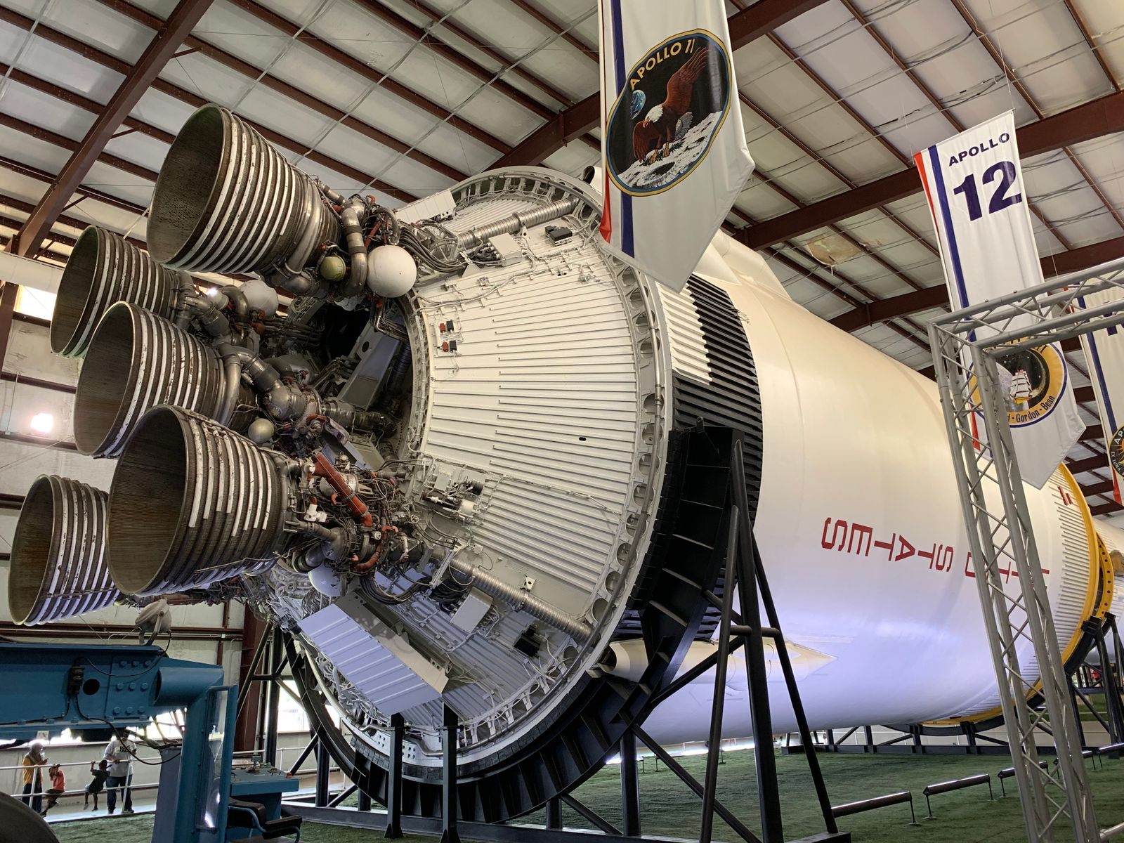 The engines and lower stage of an Apollo-era Saturn V rocket on display inside a hall at Space Center Houston